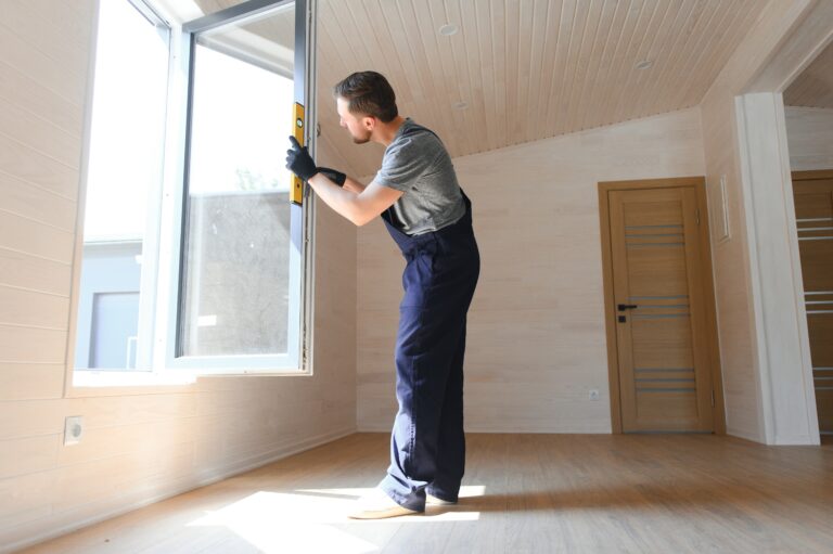A worker installs windows in a new modular home. The concept of a new home